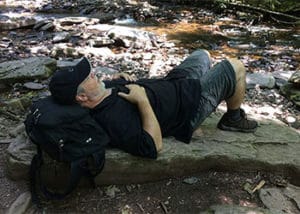 man napping on rocks