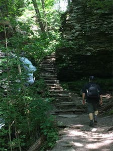 man hiking rickett's glen state park falls trail